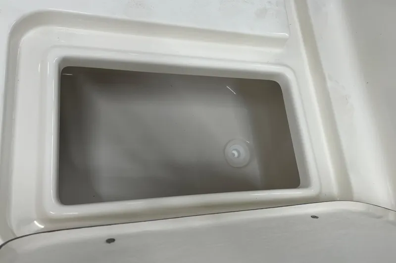 Slide: The Image of Livewell compartment in 2026 Bulls Bay 2000 boat, featuring a clean, white interior. - 12
