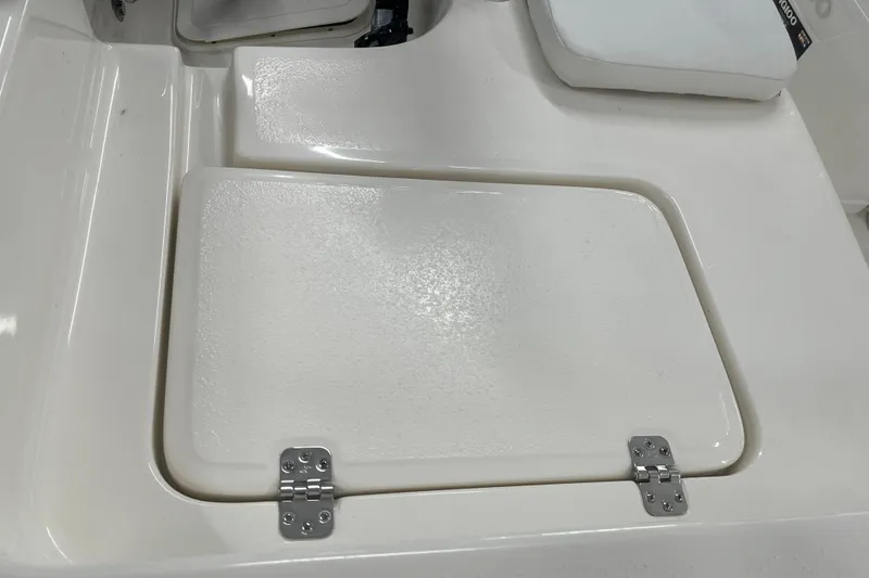 Slide: The Image of Hinged compartment on 2026 Bulls Bay 2000 boat deck, featuring a sleek white finish. - 13