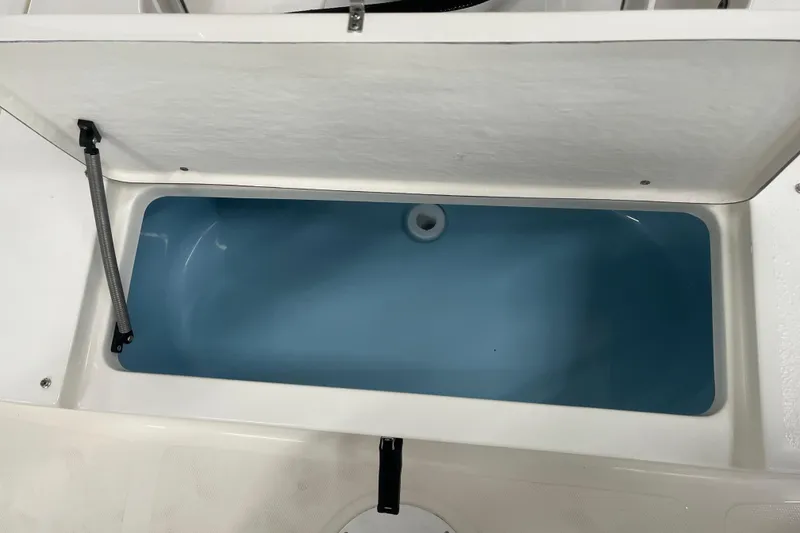 Slide: The Image of Open storage compartment in 2026 Bulls Bay 2000 boat, featuring a blue interior. - 15