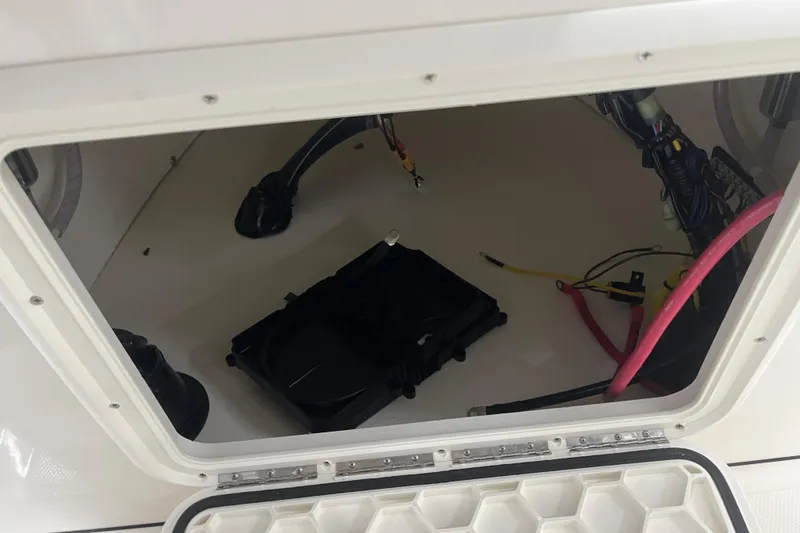 Slide: The Image of Open compartment of a 2026 Bulls Bay 2000 boat, showing wiring and components. - 17