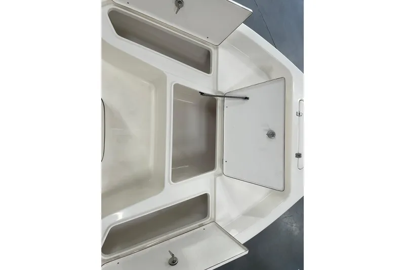 Slide: The Image of Open storage compartments on a 2026 Bulls Bay 2000 boat, showcasing ample space and design. - 18