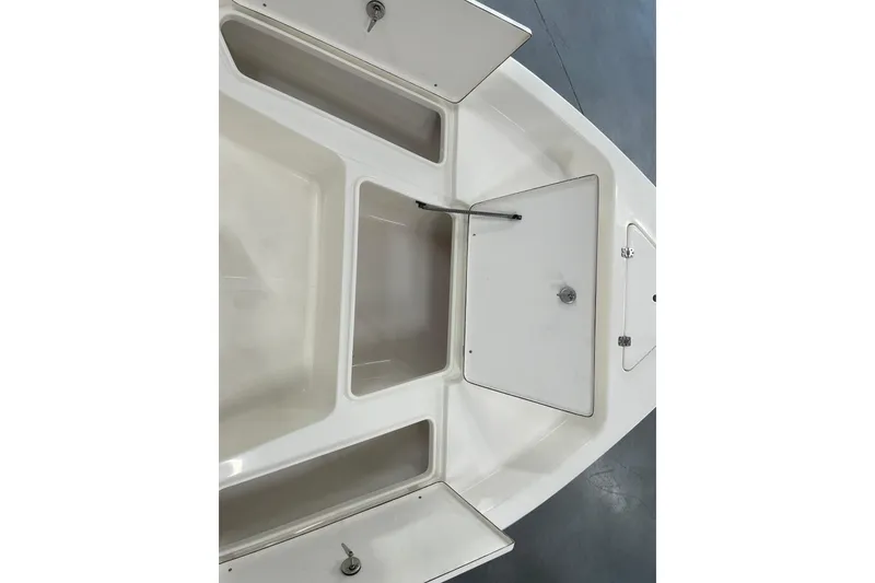 Slide: The Image of 2026 Bulls Bay 2000 boat storage compartments with open hatches, showcasing ample space. - 19