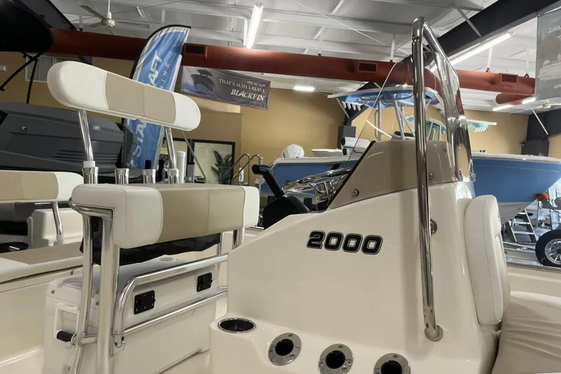 Slide: The Image of 2026 Bulls Bay 2000 boat interior with seating and console in showroom. - 20