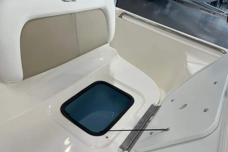 Slide: The Image of 2026 Bulls Bay 2000 boat interior with cushioned seating and storage compartment. - 22