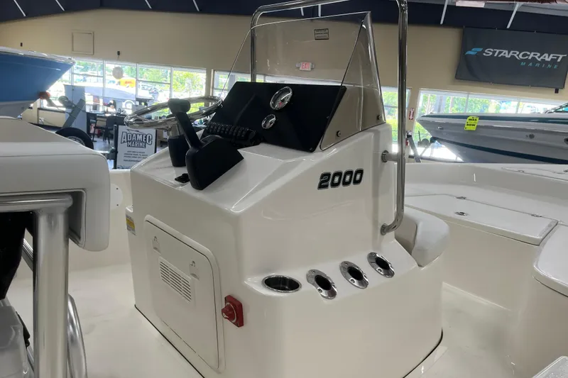 Slide: The Image of 2026 Bulls Bay 2000 boat console in showroom, featuring steering wheel and control panel. - 23