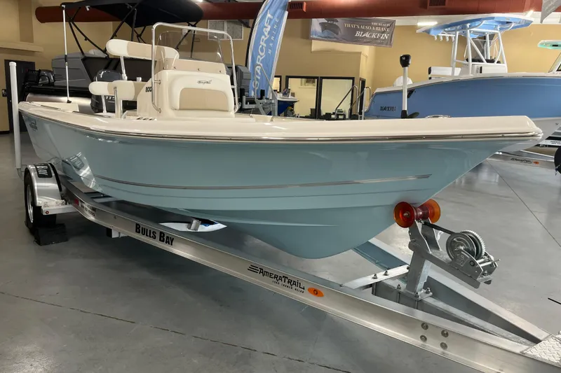 Slide: The Image of 2026 Bulls Bay 2000 boat on trailer in showroom, featuring sleek design and light blue hull. - 5