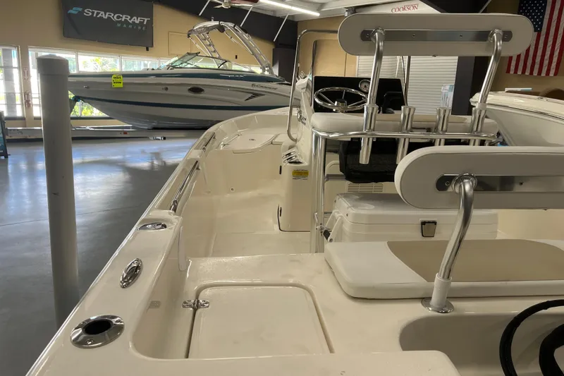Slide: The Image of 2026 Bulls Bay 2000 boat interior in showroom, featuring seating and steering console. - 8