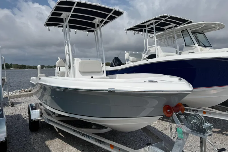 Slide: The Image of 2026 Clearwater 1900 Center Console boat by the water. - 2