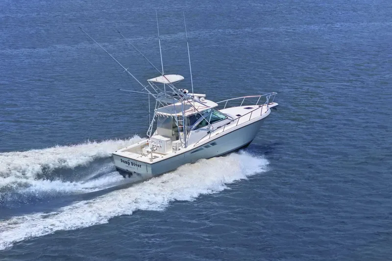 Slide: The Image of 2005 Rampage 38 Express boat cruising on open water. - 11