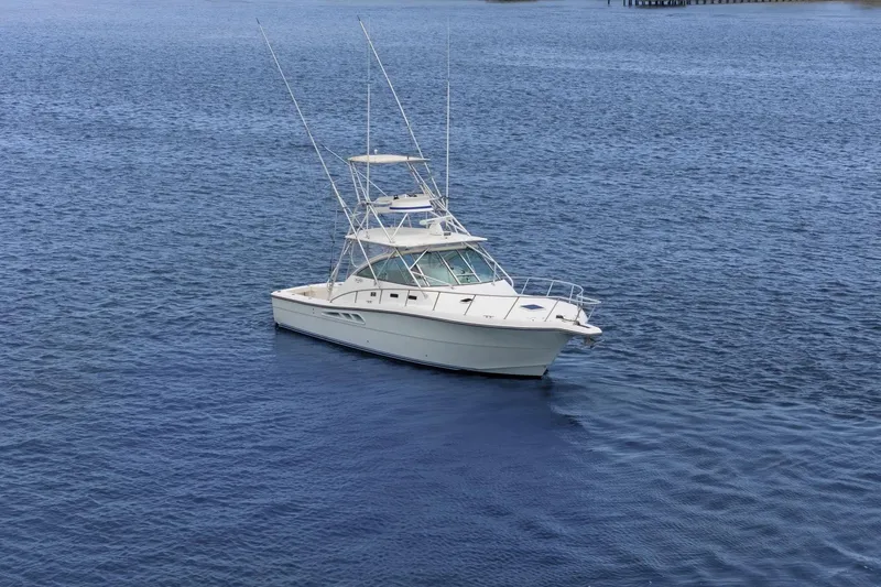 Slide: The Image of 2005 Rampage 38 Express boat on calm blue water. - 14