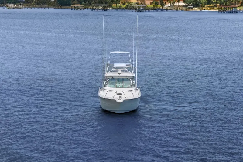 Slide: The Image of 2005 Rampage 38 Express boat on calm blue water, front view. - 15