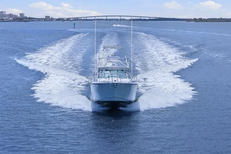Slide: The Image of 2005 Rampage 38 Express boat cruising on open water, leaving a wake behind. - 16