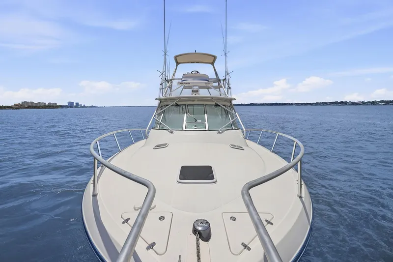 Slide: The Image of 2005 Rampage 38 Express yacht cruising on open water under clear skies. - 18