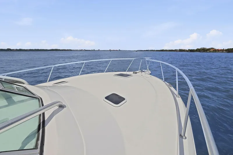 Slide: The Image of Bow view of 2005 Rampage 38 Express yacht cruising on open water. - 20