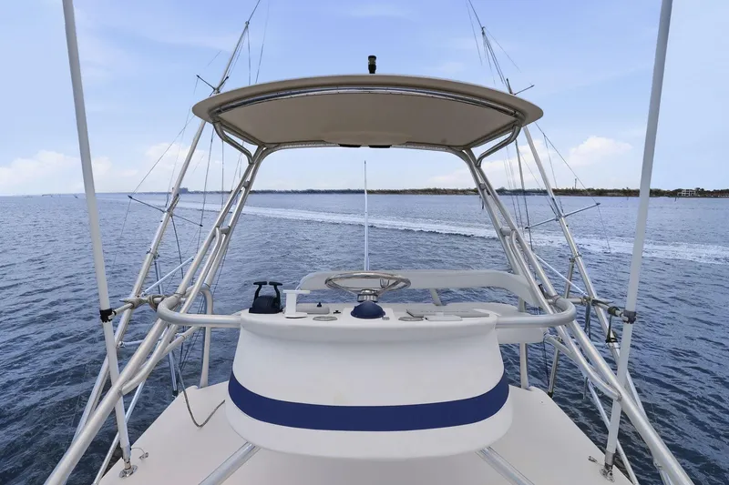 Slide: The Image of 2005 Rampage 38 Express boat helm with ocean view and clear sky. - 22