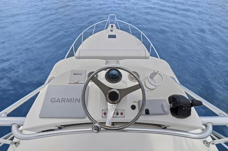 Slide: The Image of ```markdown Helm of 2005 Rampage 38 Express boat with Garmin navigation system. ``` - 24