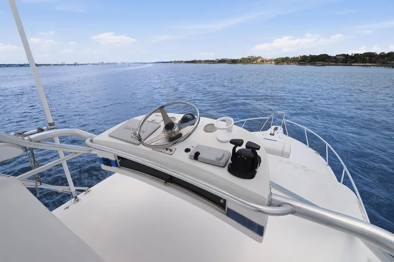 Slide: The Image of 2005 Rampage 38 Express boat helm with ocean view and clear sky. - 25