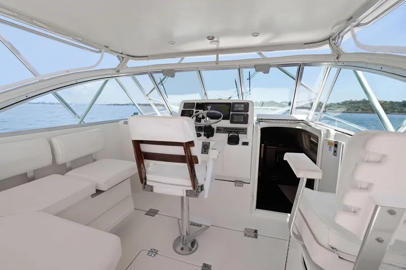 Slide: The Image of 2005 Rampage 38 Express boat interior with helm, seating, and ocean view. - 26