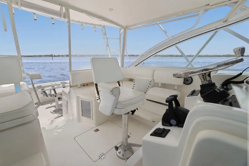 Slide: The Image of Interior view of 2005 Rampage 38 Express boat helm with ocean backdrop. - 29