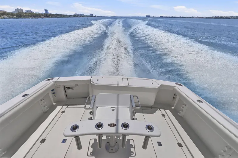 Slide: The Image of 2005 Rampage 38 Express boat cruising on open water, leaving a wake behind. - 36