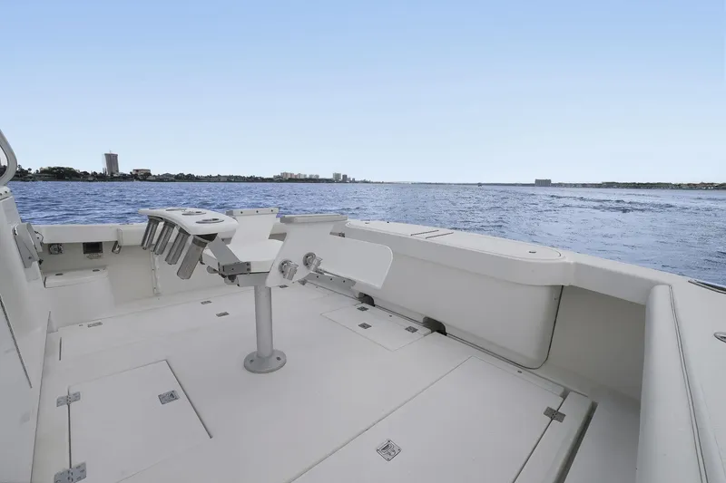 Slide: The Image of 2005 Rampage 38 Express boat deck overlooking calm waters and distant shoreline. - 37
