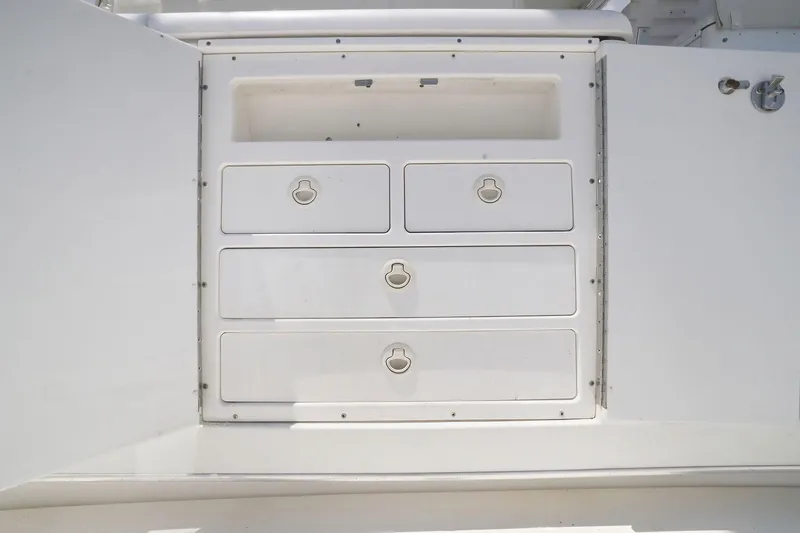 Slide: The Image of Storage drawers on a 2005 Rampage 38 Express boat, featuring sleek white design. - 40
