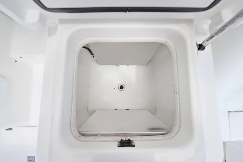 Slide: The Image of Open storage compartment on a 2005 Rampage 38 Express boat, featuring a clean, white interior. - 41