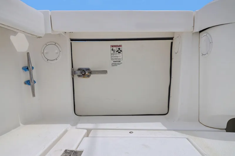 Slide: The Image of 2005 Rampage 38 Express boat deck with safety warning sign and latch. - 44