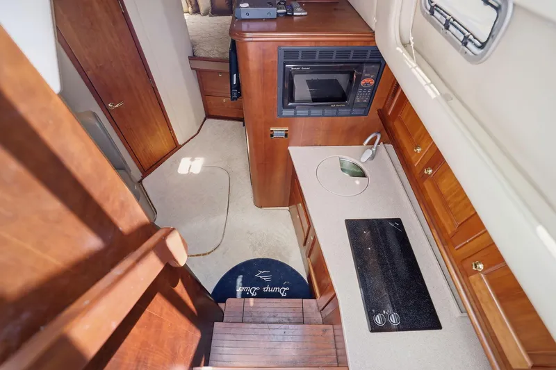 Slide: The Image of Interior of 2005 Rampage 38 Express yacht featuring kitchen with microwave and stove. - 48