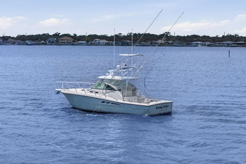 Slide: The Image of 2005 Rampage 38 Express boat on calm water with distant shoreline. - 5