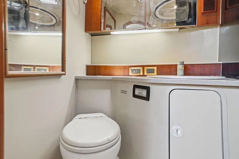 Slide: The Image of 2005 Rampage 38 Express yacht bathroom with modern fixtures and wooden cabinetry. - 53