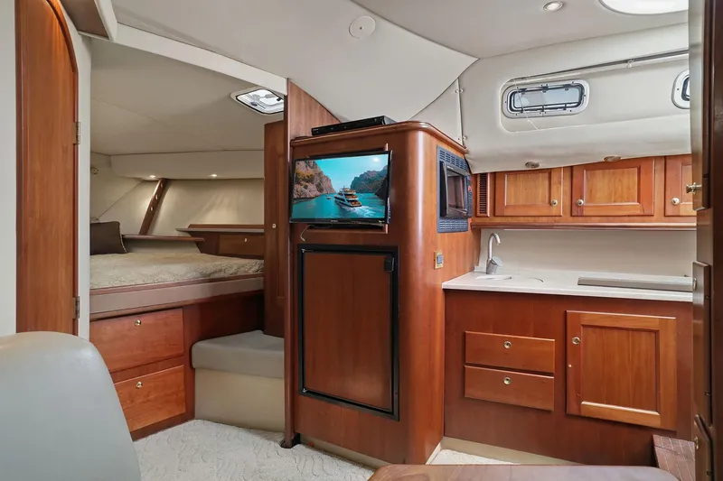 Slide: The Image of Interior of 2005 Rampage 38 Express yacht with wood cabinetry and cozy sleeping area. - 54