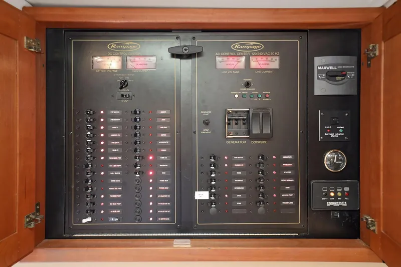 Slide: The Image of Electrical control panel of a 2005 Rampage 38 Express boat, featuring switches and gauges. - 58