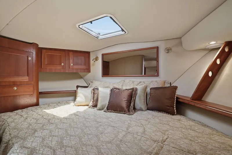 Slide: The Image of Luxurious cabin interior of 2005 Rampage 38 Express yacht with plush bedding and wooden cabinetry. - 60