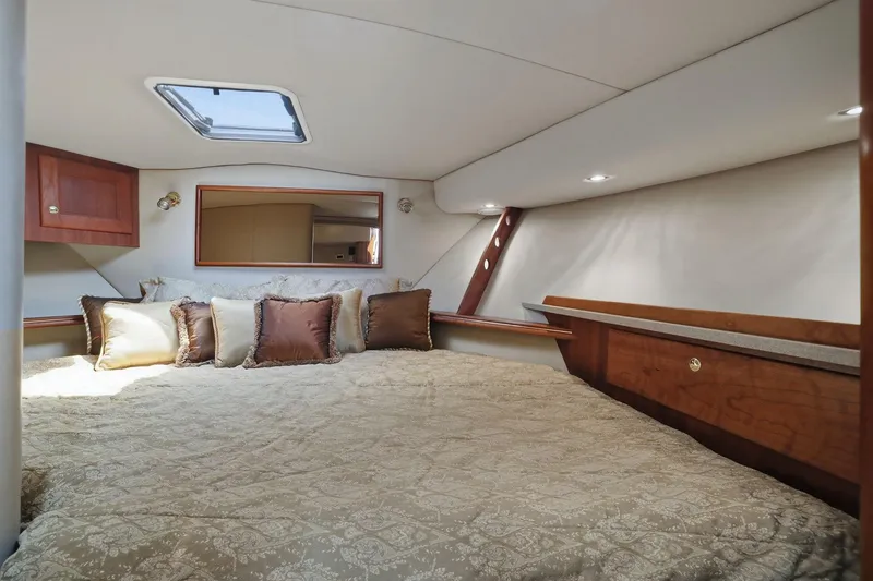 Slide: The Image of Luxurious cabin interior of 2005 Rampage 38 Express yacht with elegant bedding and wood accents. - 61