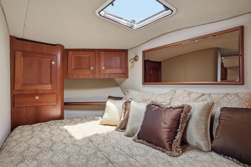 Slide: The Image of Luxurious cabin interior of 2005 Rampage 38 Express yacht with plush bedding and wooden cabinetry. - 62