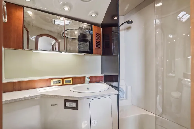 Slide: The Image of Luxurious bathroom interior of 2005 Rampage 38 Express yacht with modern fixtures and wood accents. - 63