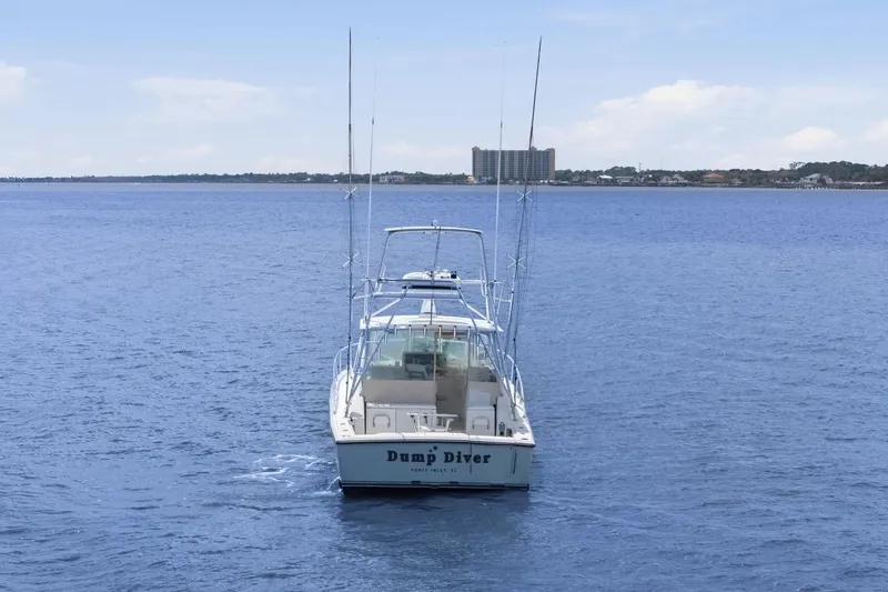 Slide: The Image of 2005 Rampage 38 Express boat on open water with distant shoreline. - 7