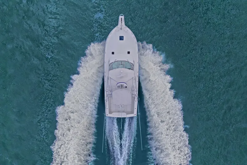 Slide: The Image of Aerial view of 2005 Rampage 38 Express boat cruising through blue waters. - 9