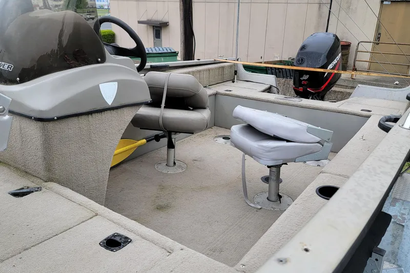 Slide: The Image of 2004 Tracker Pro Deep V-16 Single Console boat interior with seating and Mercury outboard motor. - 4