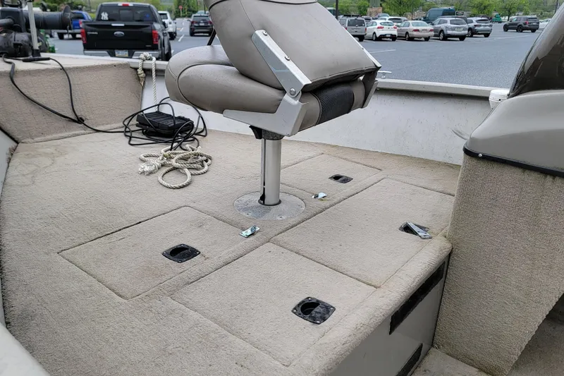 Slide: The Image of 2004 Tracker Pro Deep V-16 boat interior with seating and storage compartments. - 5