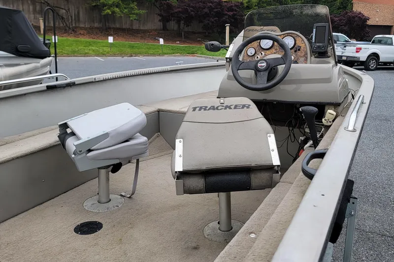 Slide: The Image of 2004 Tracker Pro Deep V-16 Single Console boat interior with steering wheel and seating. - 8