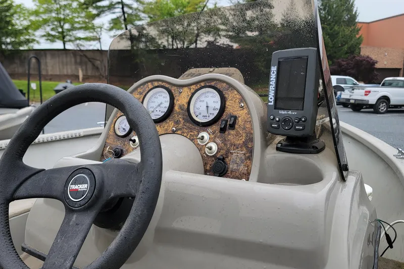 Slide: The Image of 2004 Tracker Pro Deep V-16 console with steering wheel and Lowrance fish finder. - 9