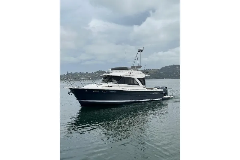 The Image of 2022 Cutwater C-32 CB boat on calm water under cloudy skies. - 0