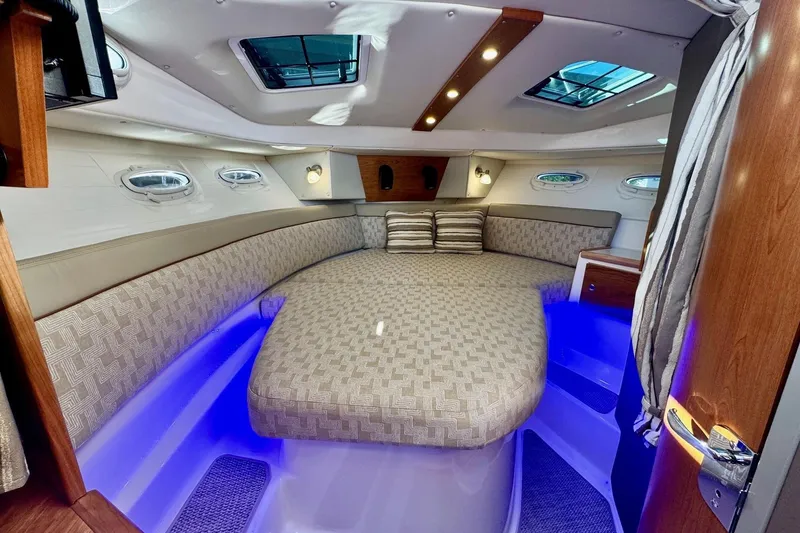 Slide: The Image of Luxurious 2022 Cutwater C-32 CB cabin interior with ambient lighting and plush bedding. - 12