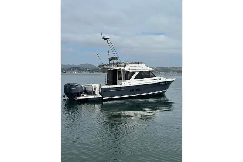 Slide: The Image of 2022 Cutwater C-32 CB boat on calm water, featuring dual Yamaha engines. - 3