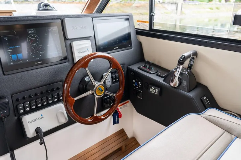Slide: The Image of Manufacturer Provided Image: 2022 Cutwater C-32 CB helm with Garmin navigation system and wooden steering wheel. - 5