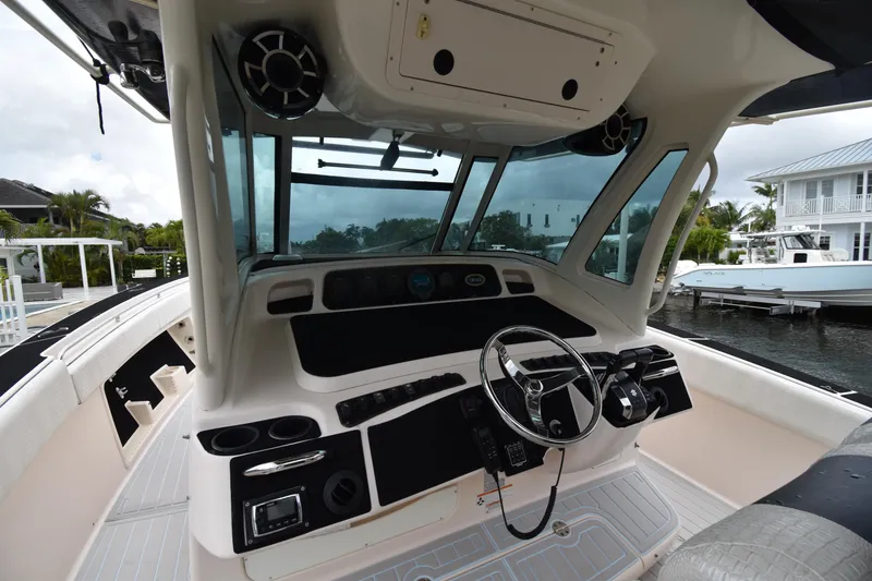 Slide: The Image of 2010 Grady-White Canyon 366 boat helm with steering wheel and controls. - 13