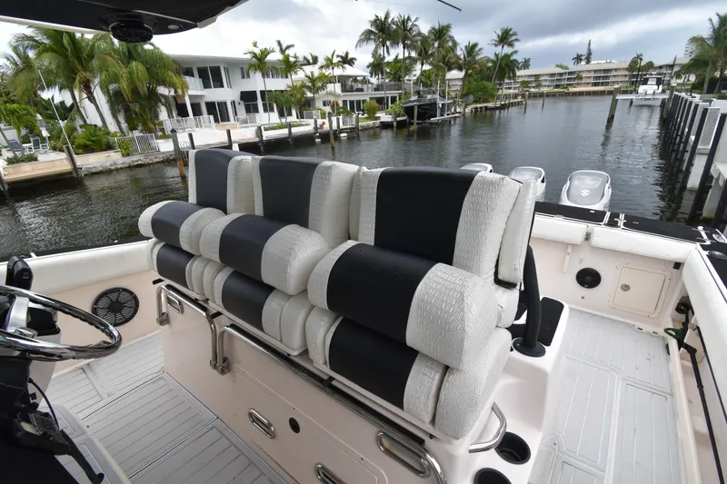 Slide: The Image of 2010 Grady-White Canyon 366 boat interior with cushioned seating, dockside view. - 15
