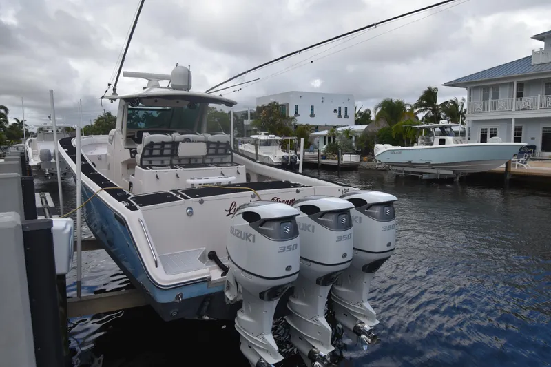 Slide: The Image of 2010 Grady-White Canyon 366 boat docked with triple Suzuki 350 engines. - 20